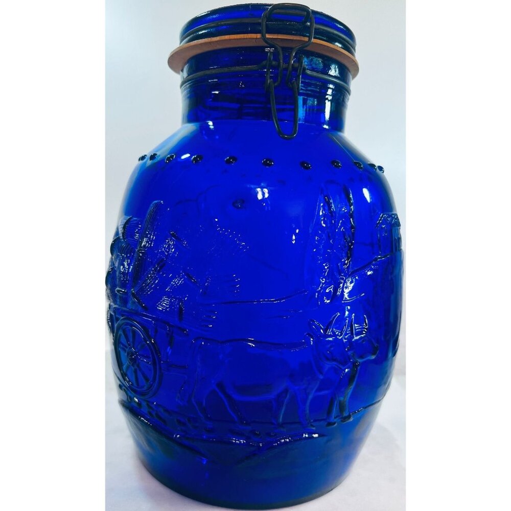 Vtg Italian Embossed Cobalt Blue Glass Jar Hinged Lid Tells a story of a farmer